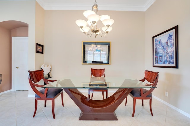 tiled dining room with an inviting chandelier, baseboards, arched walkways, and ornamental molding