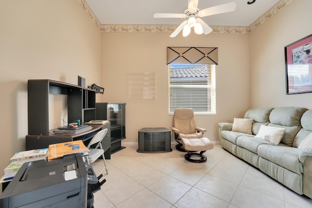 office space with ceiling fan, baseboards, and light tile patterned floors