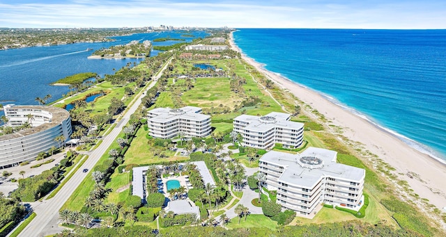 bird's eye view featuring a water view and a beach view