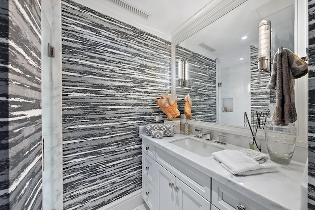 bathroom featuring visible vents, vanity, and tile walls