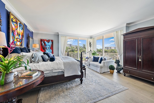 bedroom with access to outside, crown molding, and wood finished floors