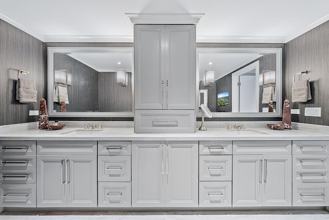 full bathroom featuring double vanity, a sink, and crown molding