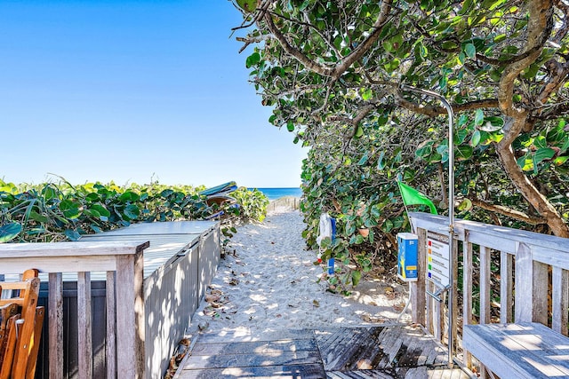 exterior space with a water view and fence