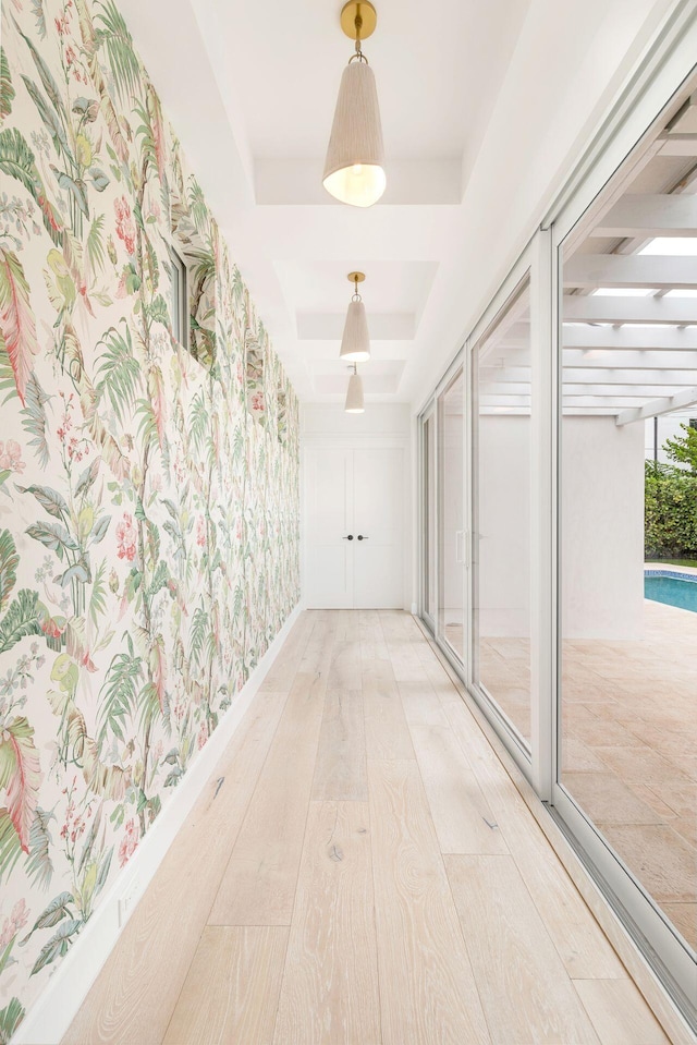 205 Greymon Dr, West Palm Beach, FL 33405 - corridor featuring wallpapered walls, wood finished floors, and a raised ceiling