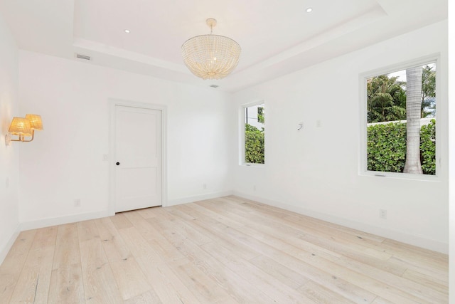 205 Greymon Dr, West Palm Beach, FL 33405 - spare room with a raised ceiling, a chandelier, light wood-style floors, baseboards, and recessed lighting