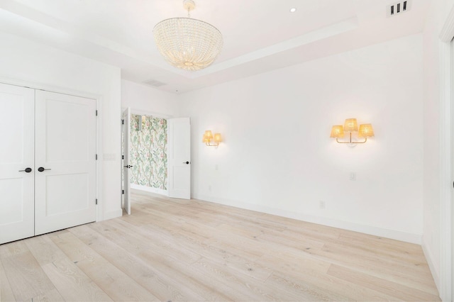 205 Greymon Dr, West Palm Beach, FL 33405 - empty room featuring wood finished floors, a chandelier, and baseboards