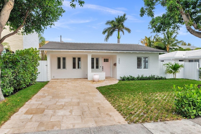 ranch-style house with brick siding, a front yard, and fence