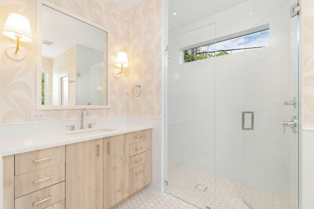 full bathroom with visible vents, vanity, a shower stall, and wallpapered walls