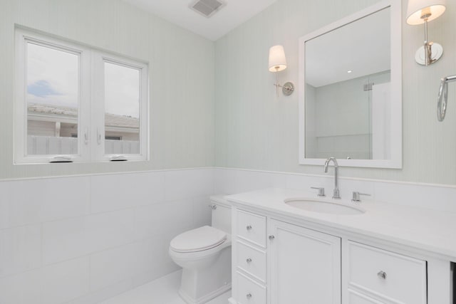 205 Greymon Dr, West Palm Beach, FL 33405 - bathroom with vanity, toilet, and wainscoting
