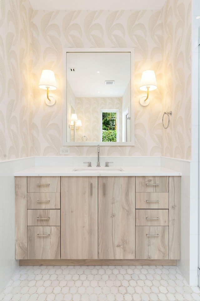 bathroom with wallpapered walls, tile patterned floors, visible vents, and vanity