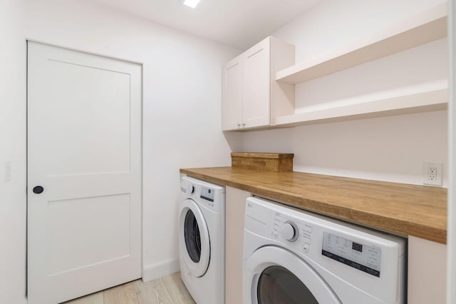 205 Greymon Dr, West Palm Beach, FL 33405 - washroom with separate washer and dryer, cabinet space, and light wood-type flooring