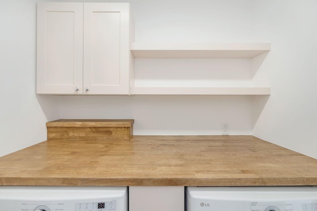 interior details with washer / dryer, white cabinetry, open shelves, and light countertops