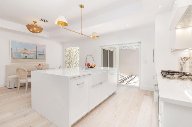 205 Greymon Dr, West Palm Beach, FL 33405 - kitchen with stainless steel gas stovetop, a sink, light wood-style floors, wall chimney exhaust hood, and recessed lighting