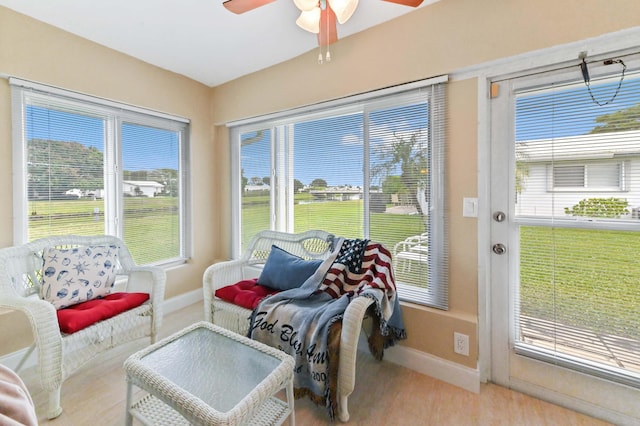 sunroom featuring ceiling fan and plenty of natural light