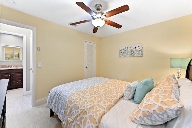 bedroom with visible vents, baseboards, a ceiling fan, a sink, and a closet