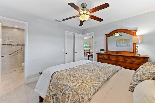 bedroom featuring visible vents, a ceiling fan, light tile patterned flooring, ensuite bath, and baseboards