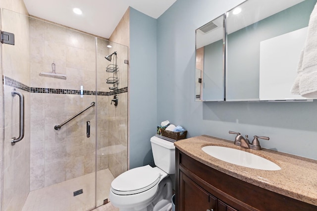 full bathroom with toilet, a shower stall, and vanity