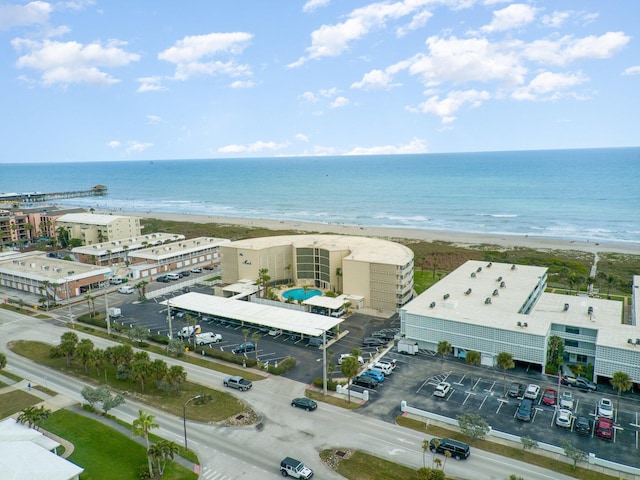 birds eye view of property featuring a beach view and a water view