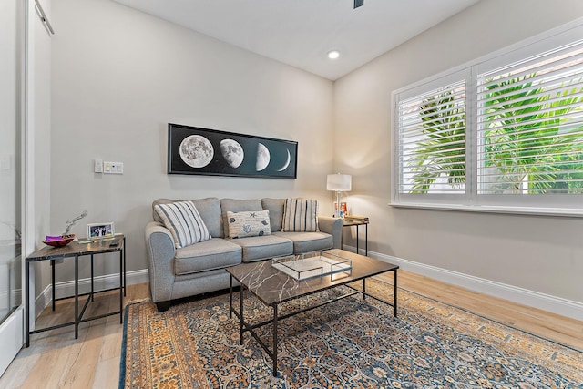 living area featuring recessed lighting, baseboards, and wood finished floors