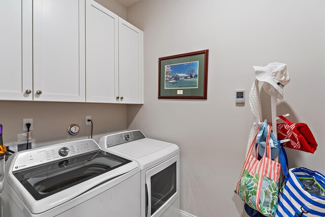 laundry room featuring cabinet space and washing machine and clothes dryer