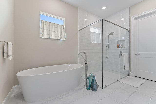 full bathroom with marble finish floor, recessed lighting, a freestanding bath, a stall shower, and baseboards