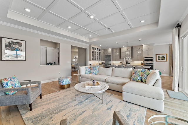 living area featuring recessed lighting, coffered ceiling, and light wood finished floors