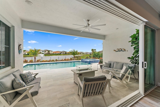 view of patio / terrace featuring ceiling fan, a fenced backyard, a water view, a pool with connected hot tub, and outdoor lounge area