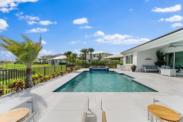 view of pool featuring a fenced backyard, a pool with connected hot tub, an outdoor living space, a ceiling fan, and a patio area