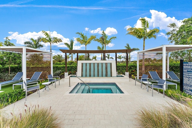 view of pool with a patio area and a hot tub