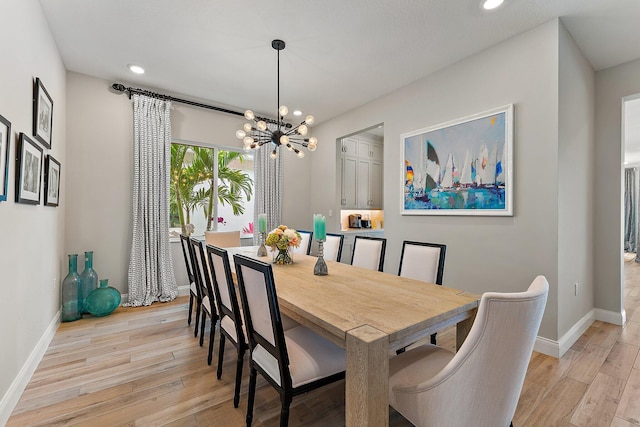 dining room featuring a notable chandelier, recessed lighting, baseboards, and light wood-style floors