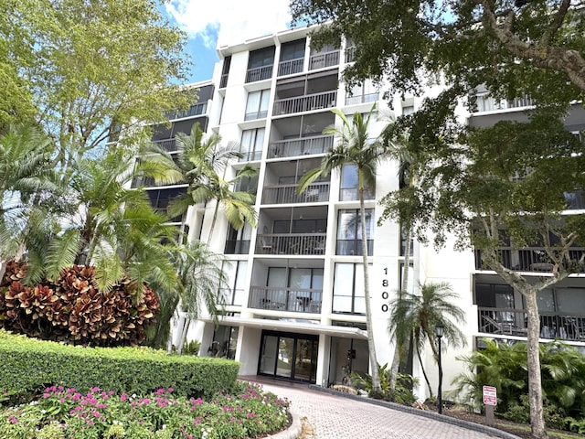 view of building exterior featuring decorative driveway