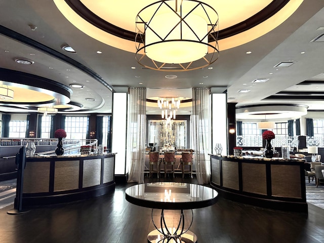 reception featuring visible vents and an inviting chandelier