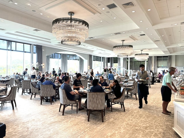 carpeted dining space featuring a chandelier, coffered ceiling, visible vents, and recessed lighting