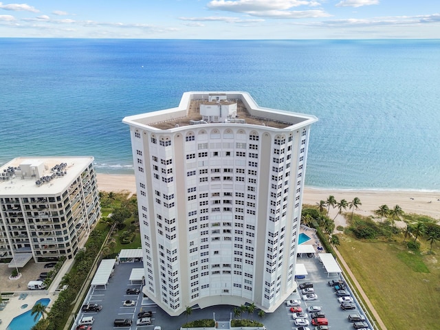 birds eye view of property featuring a view of the beach and a water view