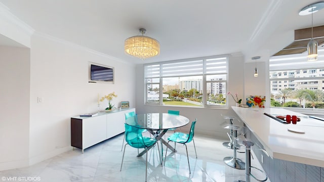 dining space with marble finish floor, baseboards, ornamental molding, and a notable chandelier