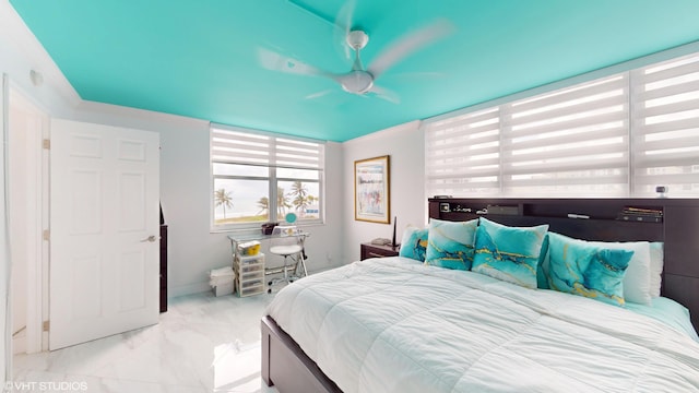 bedroom with marble finish floor, ornamental molding, and baseboards