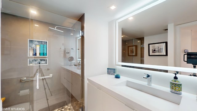 full bathroom featuring a stall shower and vanity