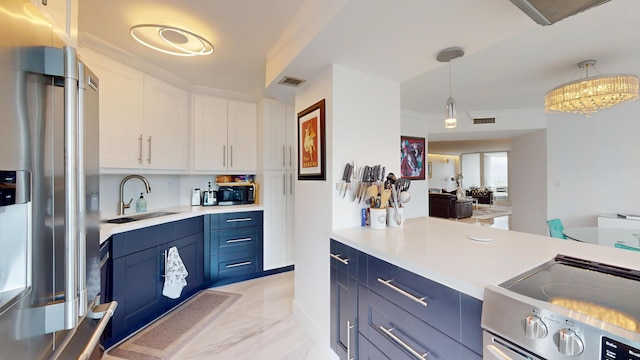 kitchen featuring visible vents, stainless steel fridge with ice dispenser, blue cabinetry, a sink, and range with electric stovetop