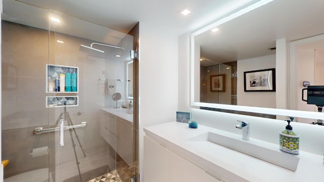 full bath with a shower stall and vanity