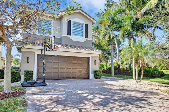 view of front of house with a garage, decorative driveway, and stucco siding