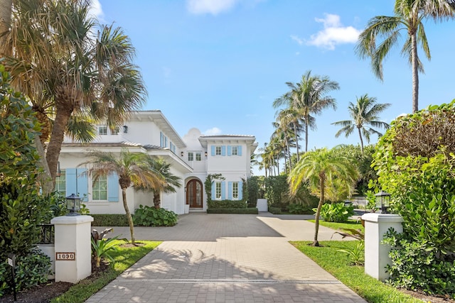 mediterranean / spanish house featuring decorative driveway and stucco siding