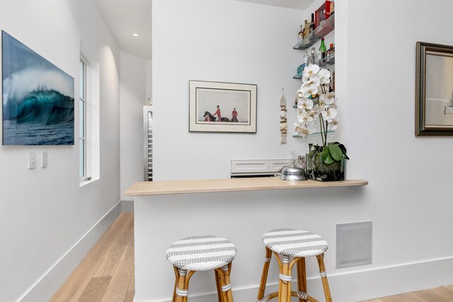 dining area with a fireplace, light wood-style flooring, and recessed lighting