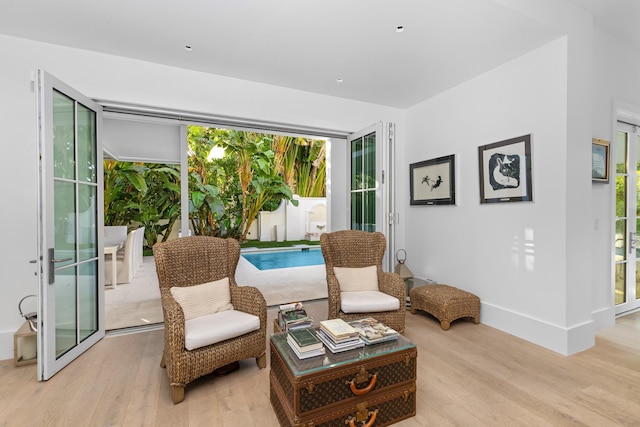 sitting room with light wood-style flooring and baseboards