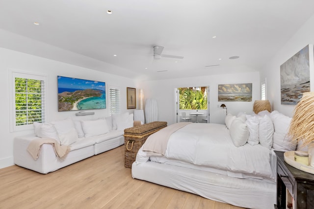 bedroom with multiple windows, wood finished floors, and a ceiling fan