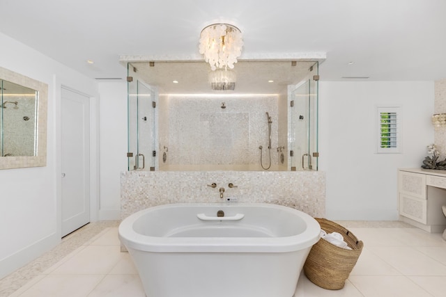 bathroom featuring a notable chandelier, a freestanding bath, a shower stall, and tile patterned floors