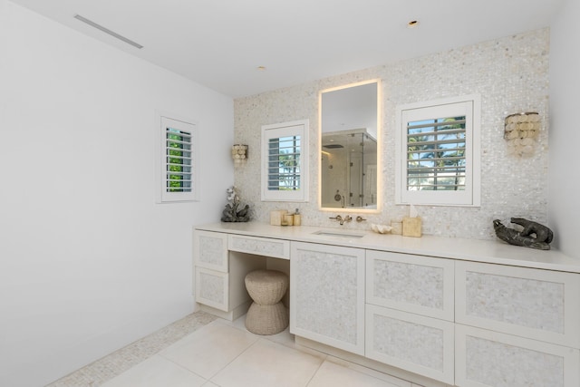 bathroom featuring vanity, walk in shower, decorative backsplash, and tile patterned floors