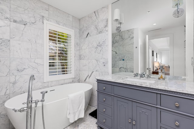 full bathroom featuring tile walls, a soaking tub, and vanity