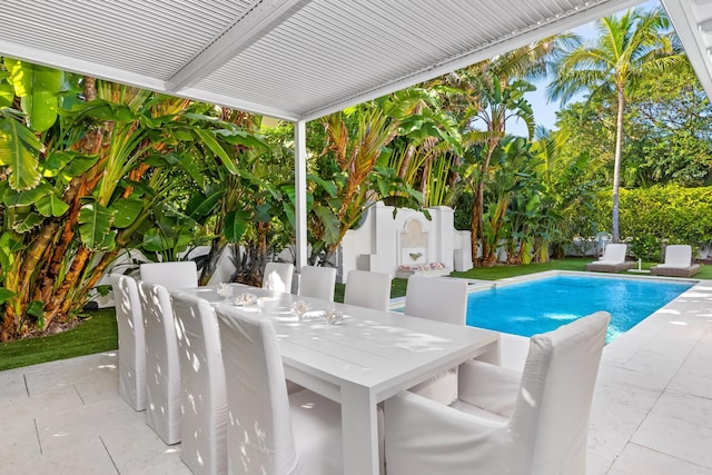 view of pool featuring a patio area, a fenced in pool, and outdoor dining space