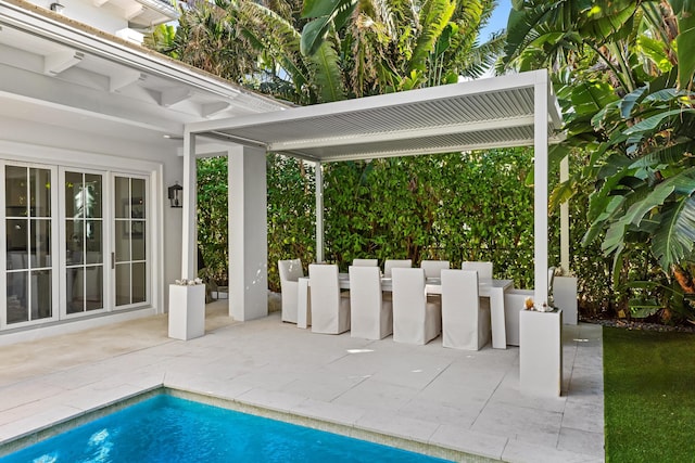 outdoor pool with a patio area, outdoor dry bar, and french doors