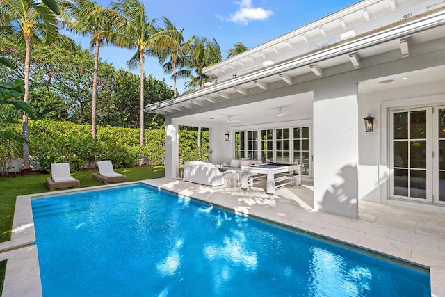 view of swimming pool with a fenced in pool, a patio, and a ceiling fan